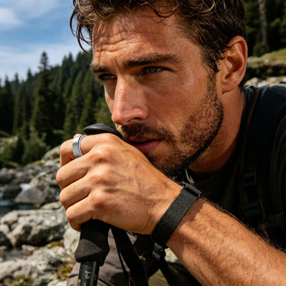 Man hiking outdoors wearing Osawalla RP01 smart ring on trekking pole